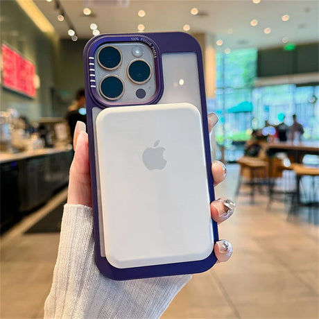 Purple-framed iPhone with MagSafe battery pack.