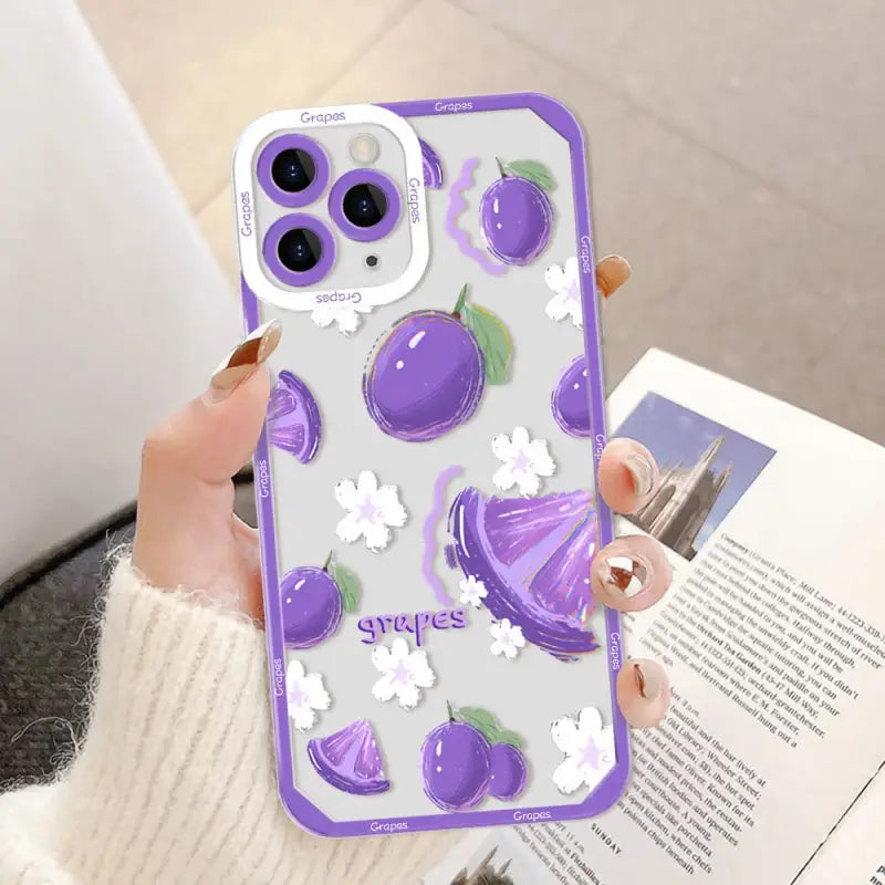 a woman holding a purple phone case with purple flowers
