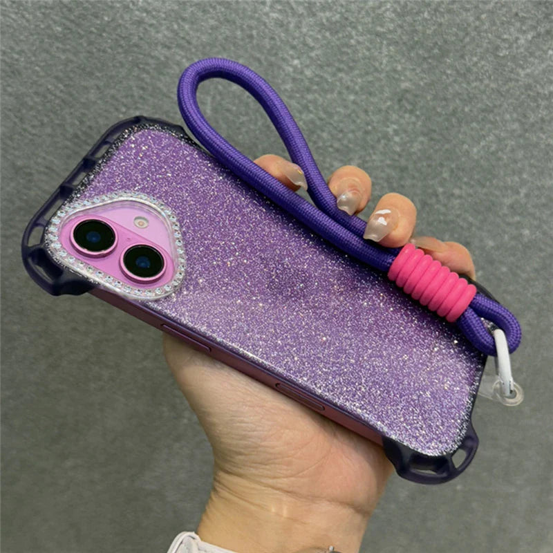 Purple glitter phone case with a purple lanyard and pink silicone ring.