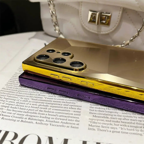 A purple and gold phone case sitting on top of a newspaper