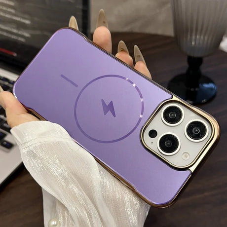 Purple iPhone case with a gold trim, MagSafe charging symbol, and a triple camera cutout.