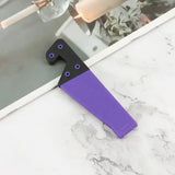 a purple knife is on the counter