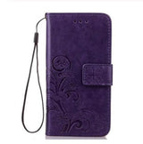 a purple leather wallet case with a floral design