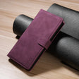 Purple leather wallet-style phone case with a closure flap.