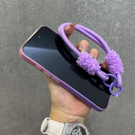 Purple phone case with fluffy strap.
