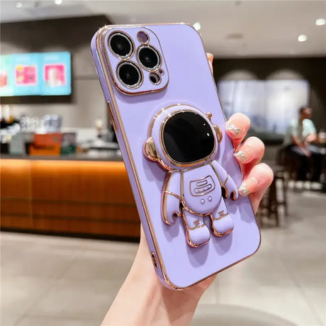 A purple phone case with a gold ring and a black phone