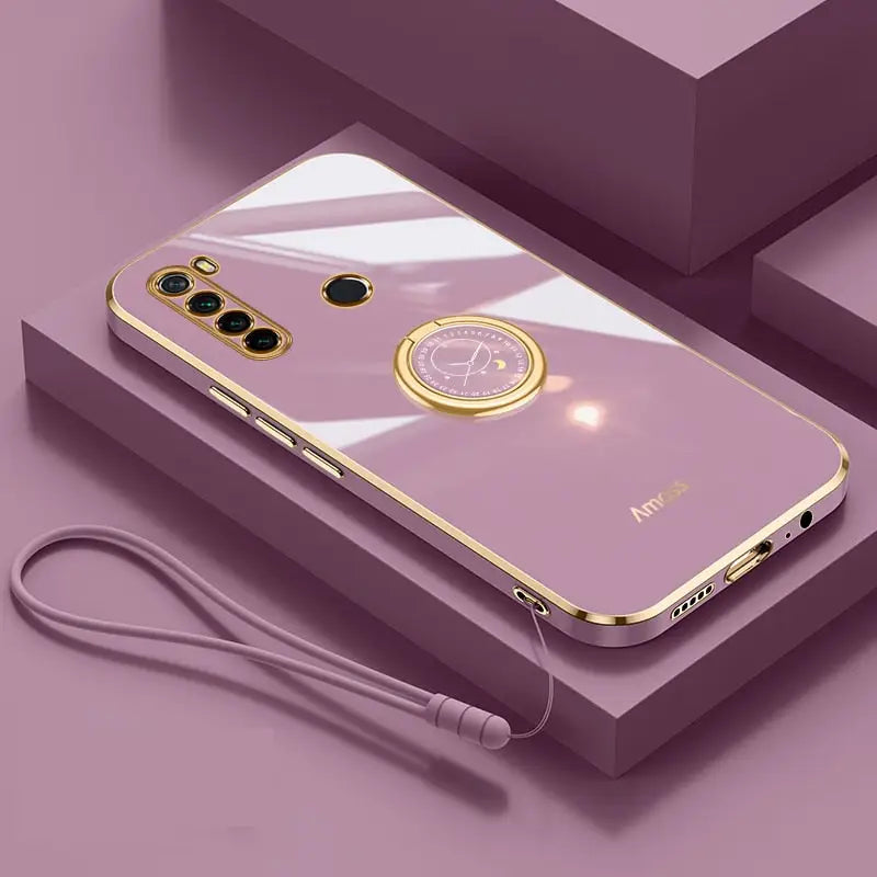 a phone with a gold case and earphones