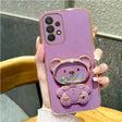 a purple phone case with a heart shaped ring