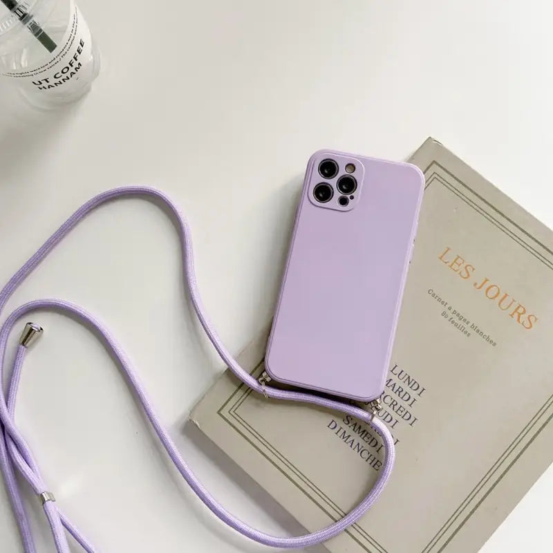 a purple phone case sitting on top of a book
