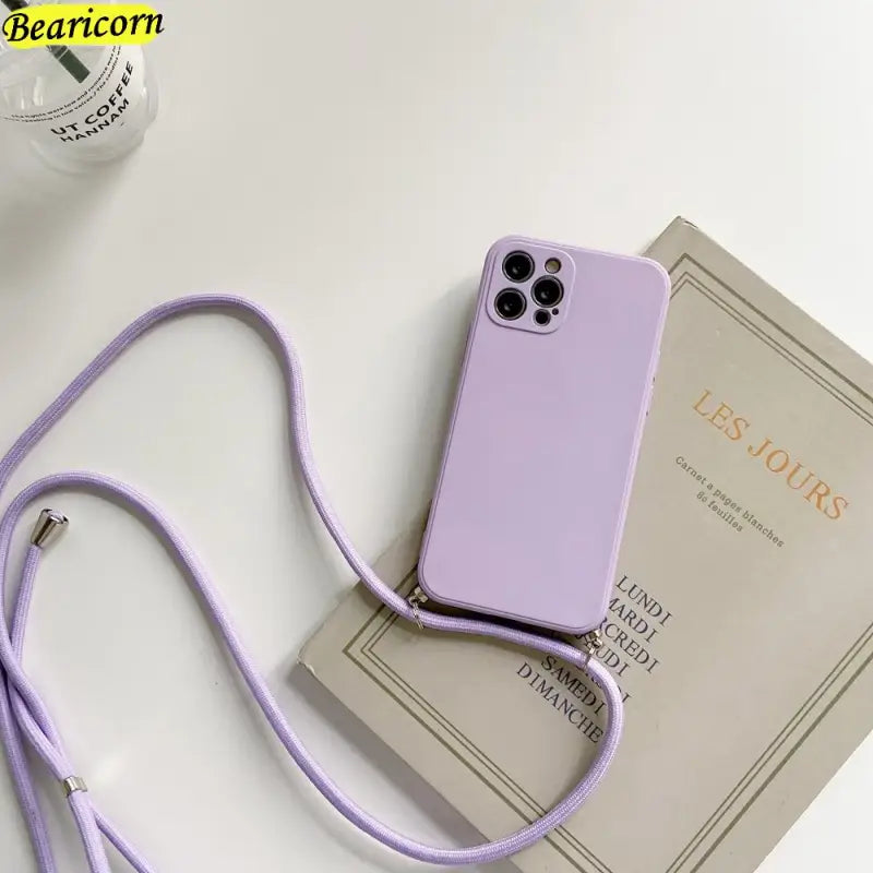 a purple phone case with a strap on top