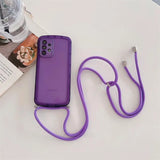 purple phone with a cord attached to it next to a book