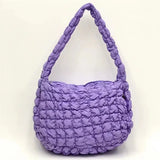 a purple purse with a large handle