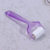 a purple toothbrush with a white toothbrush on it