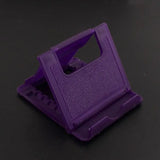 a purple plastic object on a black surface