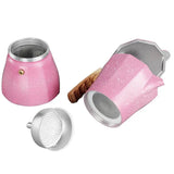there are two pink tea pots and a tea strainer