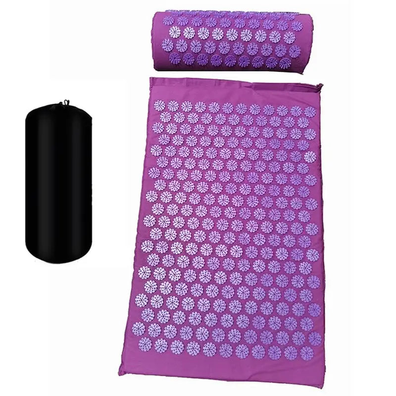 a purple mat with a black candle and a purple towel
