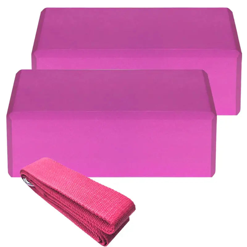 purple yoga blocks with a pink towel on top of them