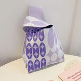 a purple and white bag sitting on top of a table