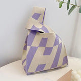 a purple and white bag sitting on a table