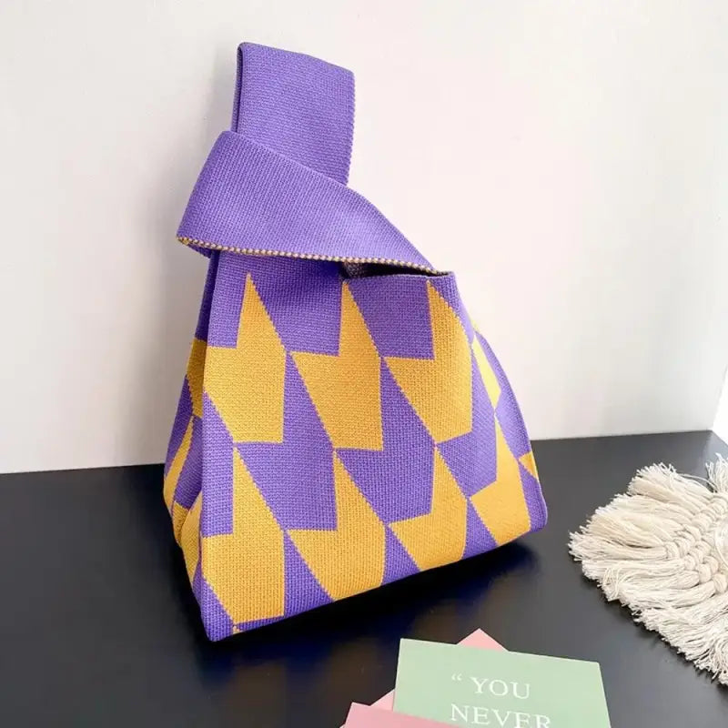 a purple and yellow bag with a note on it