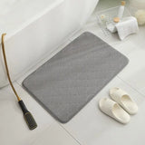 a bath mat with a brush and a towel
