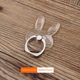 a rabbit head shaped ring on a wooden table