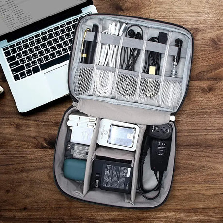 a laptop and a bag on a wooden table