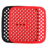 a red and black plastic cutting board with holes