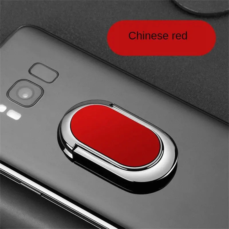 a red button on the back of a black phone