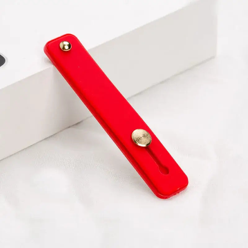 A red door handle on a white surface