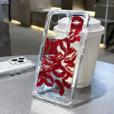 a red flower phone case on a table