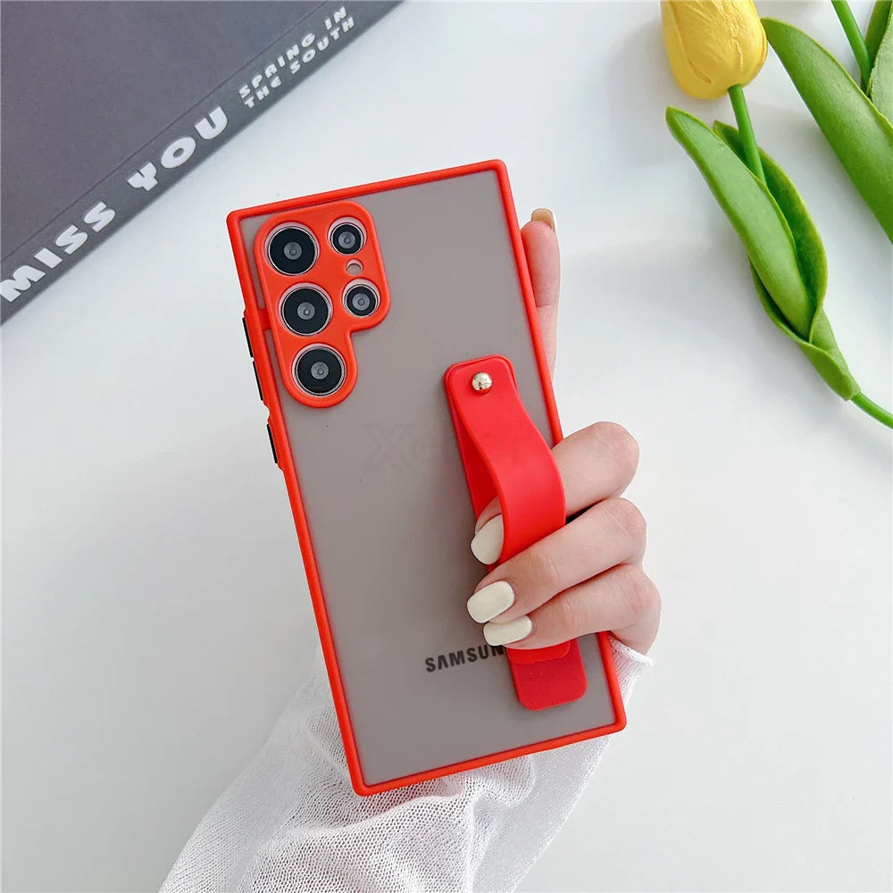Red-framed phone case with a transparent back and integrated red strap.