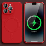 Red iPhone with MagSafe charging capability, displaying a battery charging icon on its screen.