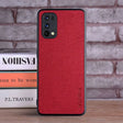 The red leather iphone case is sitting on a stack of books