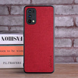 the red leather iphone case is sitting on a stack of books