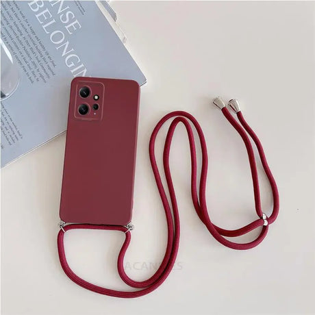 There is a red phone case with a red cord attached to it