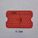 a red plastic card with white dots