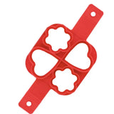 a red plastic cutter with four holes