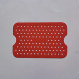 a red plastic placemat with white dots