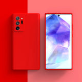 Red smartphone with a triple camera setup and a colorful display showing geometric shapes.