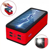 a red solar power bank with a hand holding it