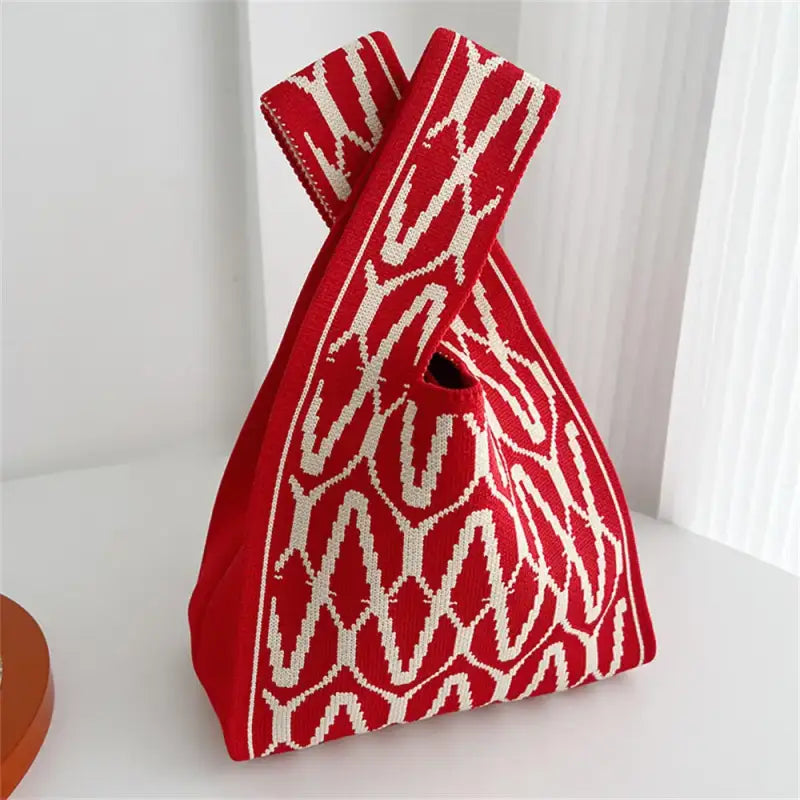 a red and white bag sitting on top of a table