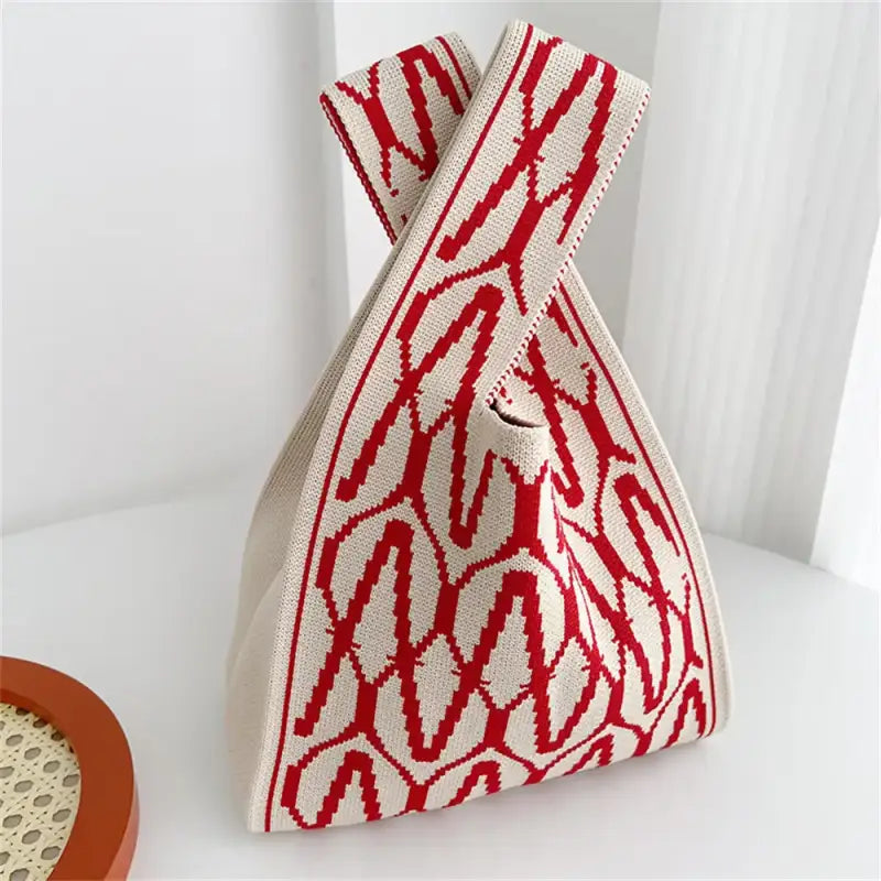 a red and white bag sitting on a table