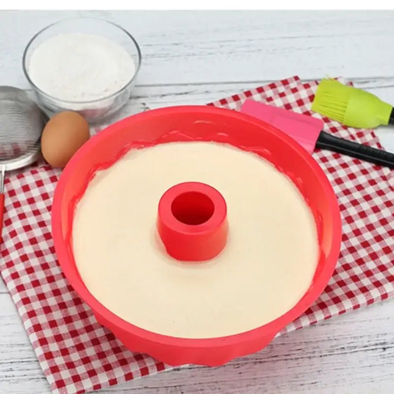 a red and white cake pan with a red handle