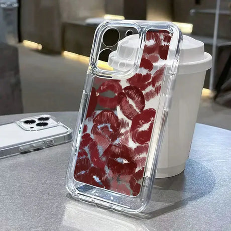 a red and white floral iphone case on a table