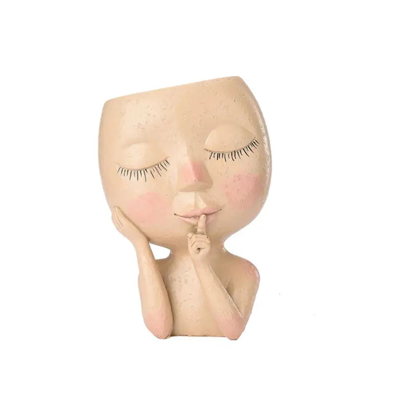 a wooden doll with a hand on its chin