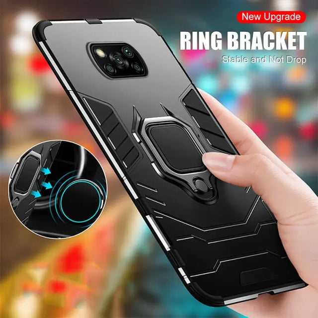 a person holding a phone with a ring bracket attached to it