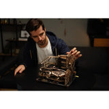 a man is working on a model of a machine