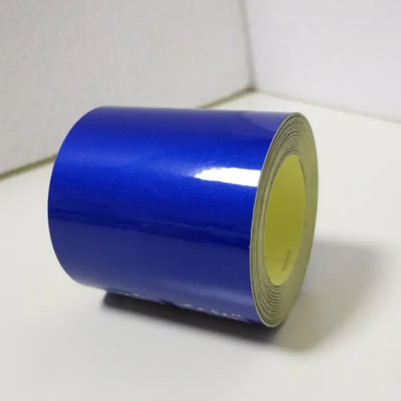 a roll of blue tape on a white surface