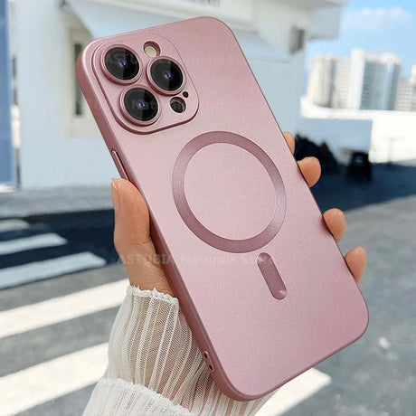 Rose gold iPhone with a triple-lens camera and MagSafe charging ring on the back.